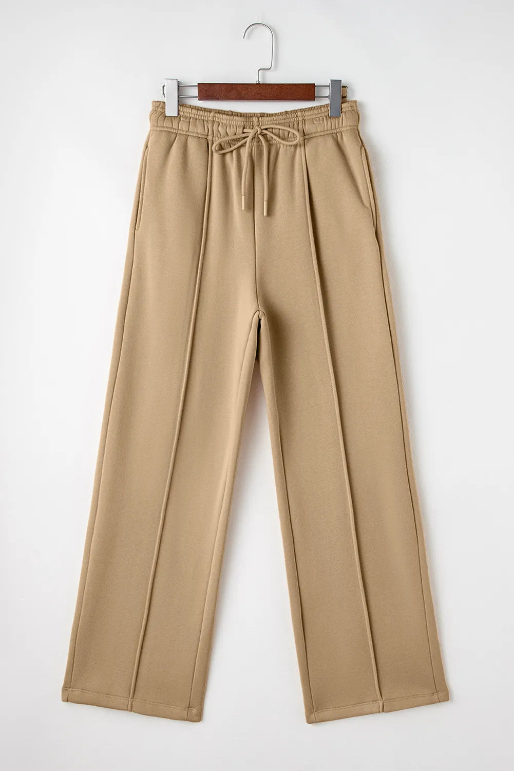Full-length front product view of tan wide-leg trousers with drawstring waist.