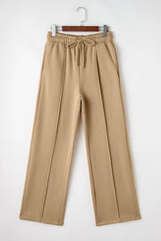 Full-length front product view of tan wide-leg trousers with drawstring waist.