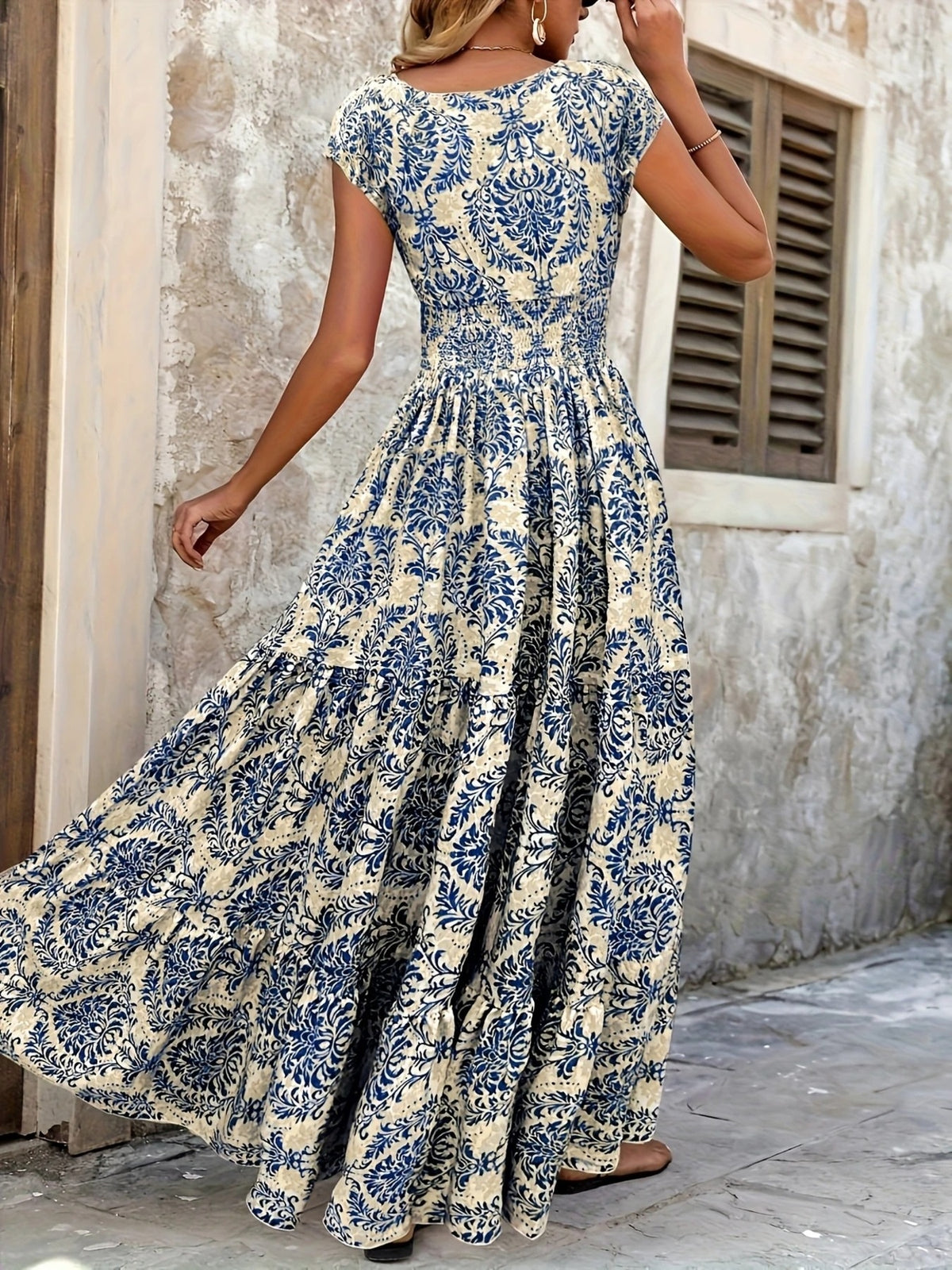 Red floral maxi dress shown front-on with a gathered waist and full skirt.