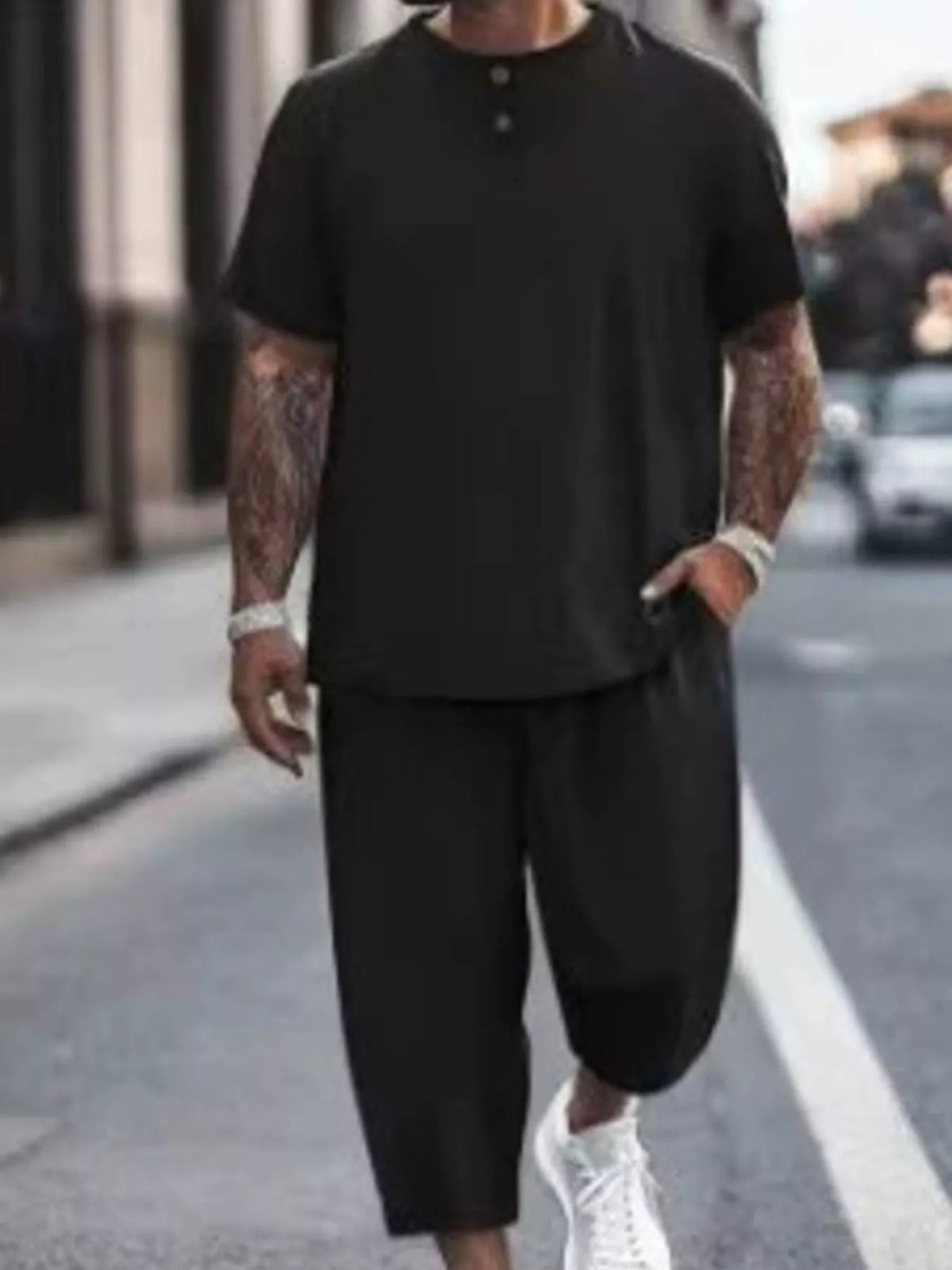 Model wearing black short-sleeve top and cropped pants
