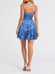Back view of the light blue mini dress showing adjustable straps and floral sequins.