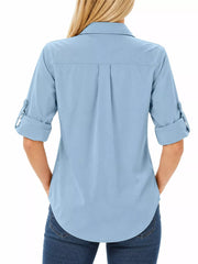 Back view of light blue button-down shirt with rolled sleeves