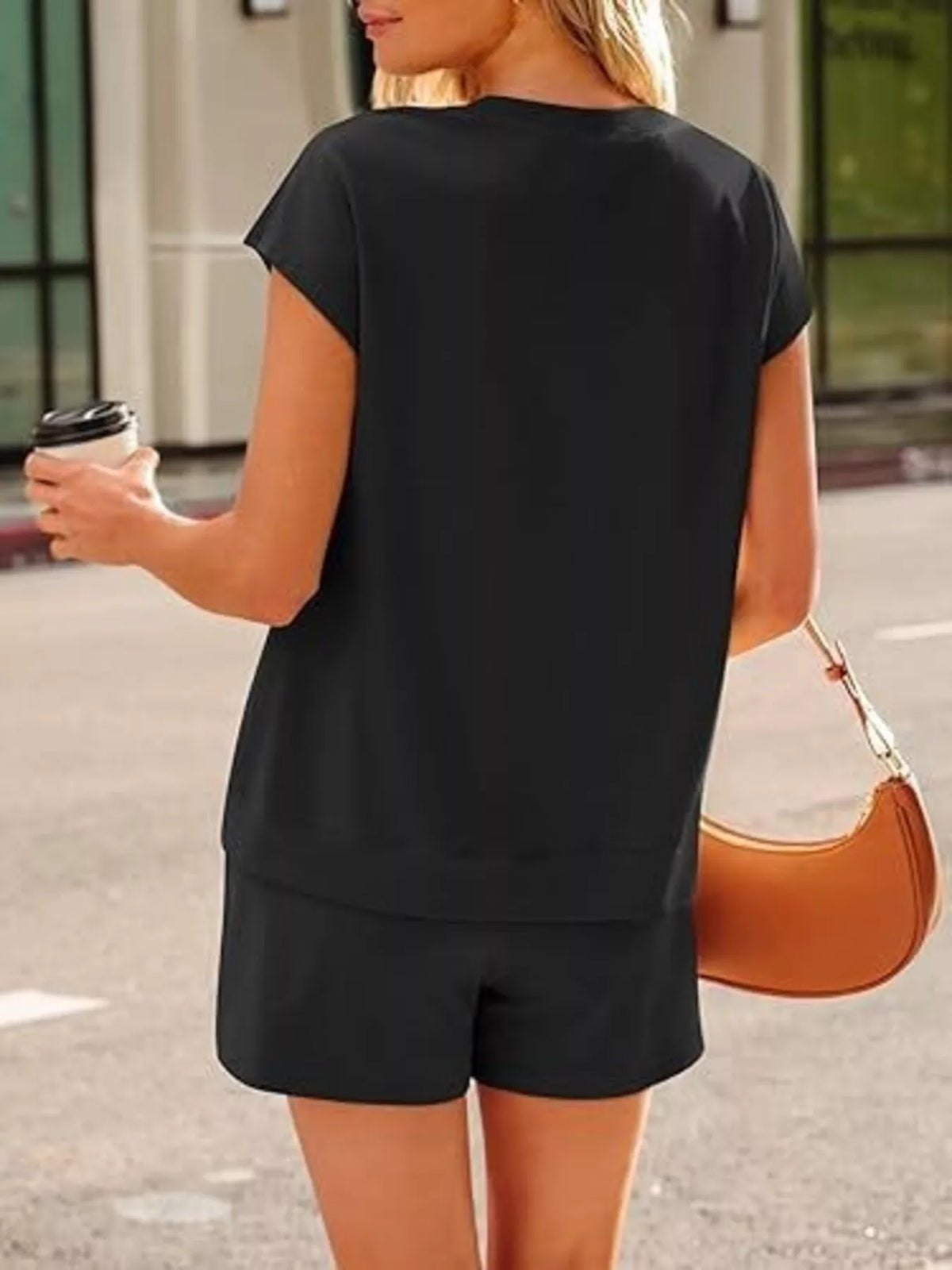 Back view of the black top and shorts, showing the relaxed cut.