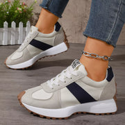 Side view of white and black sneakers showing layered white soles