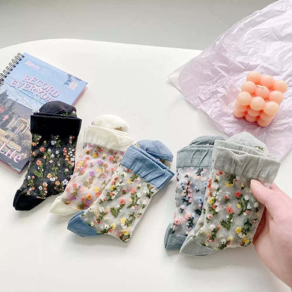 Folded floral sheer socks showing assorted colors and flower patterns