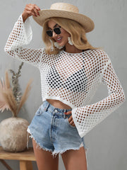 White openwork cropped cover-up with flared sleeves, shown with denim shorts.