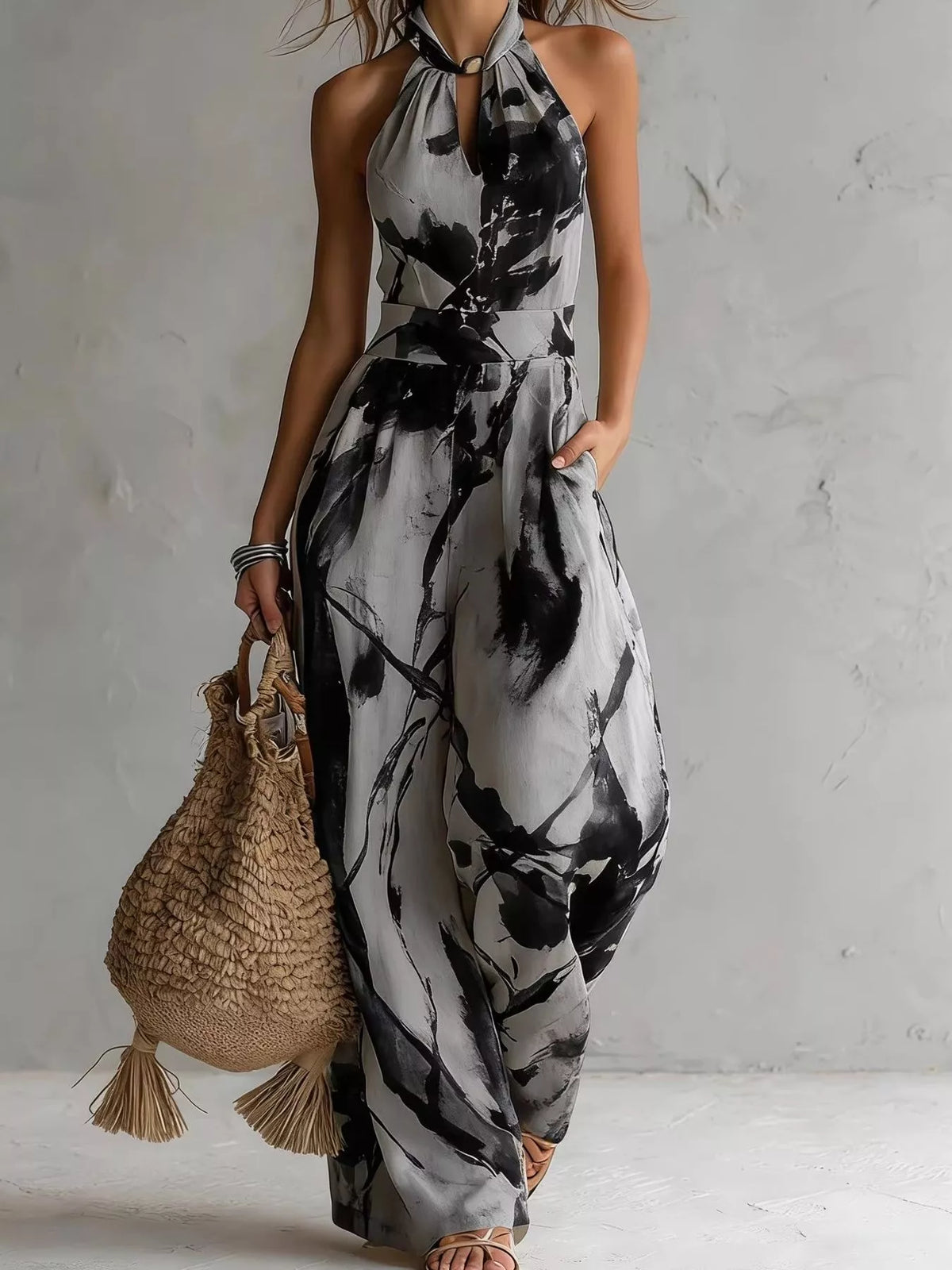 Grey and black ink-wash halter jumpsuit, full-length front view.