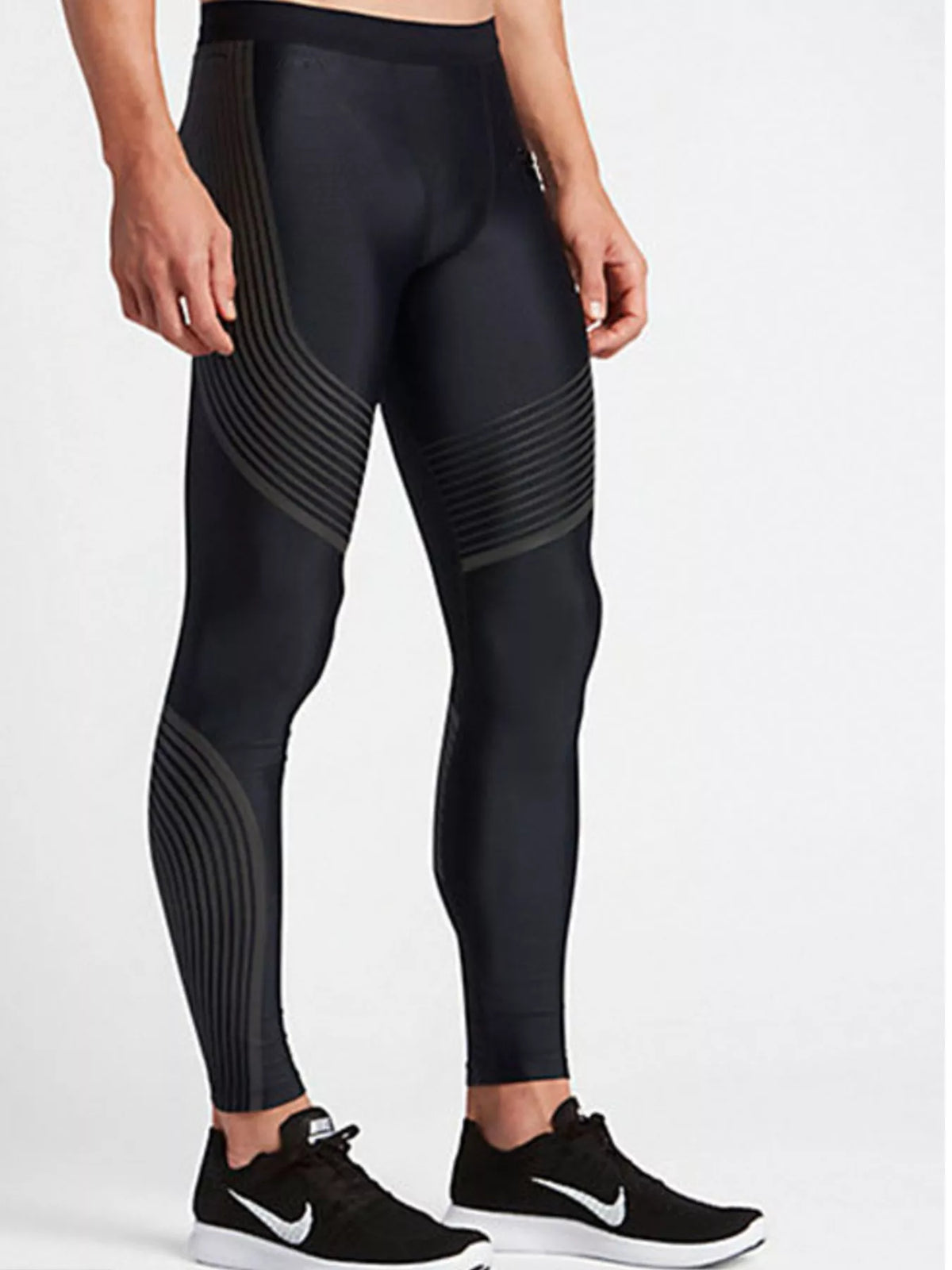 Black fitted active leggings with curved gray thigh and calf lines, modeled front view