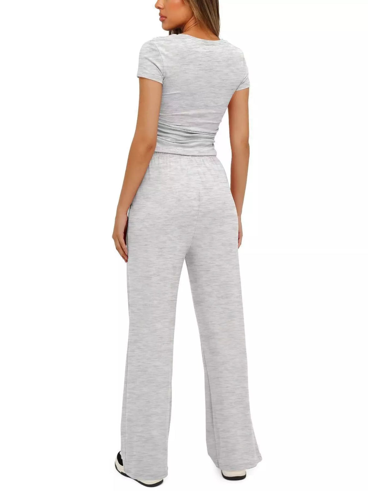 Back view of the white tank and matching wide-leg pants.
