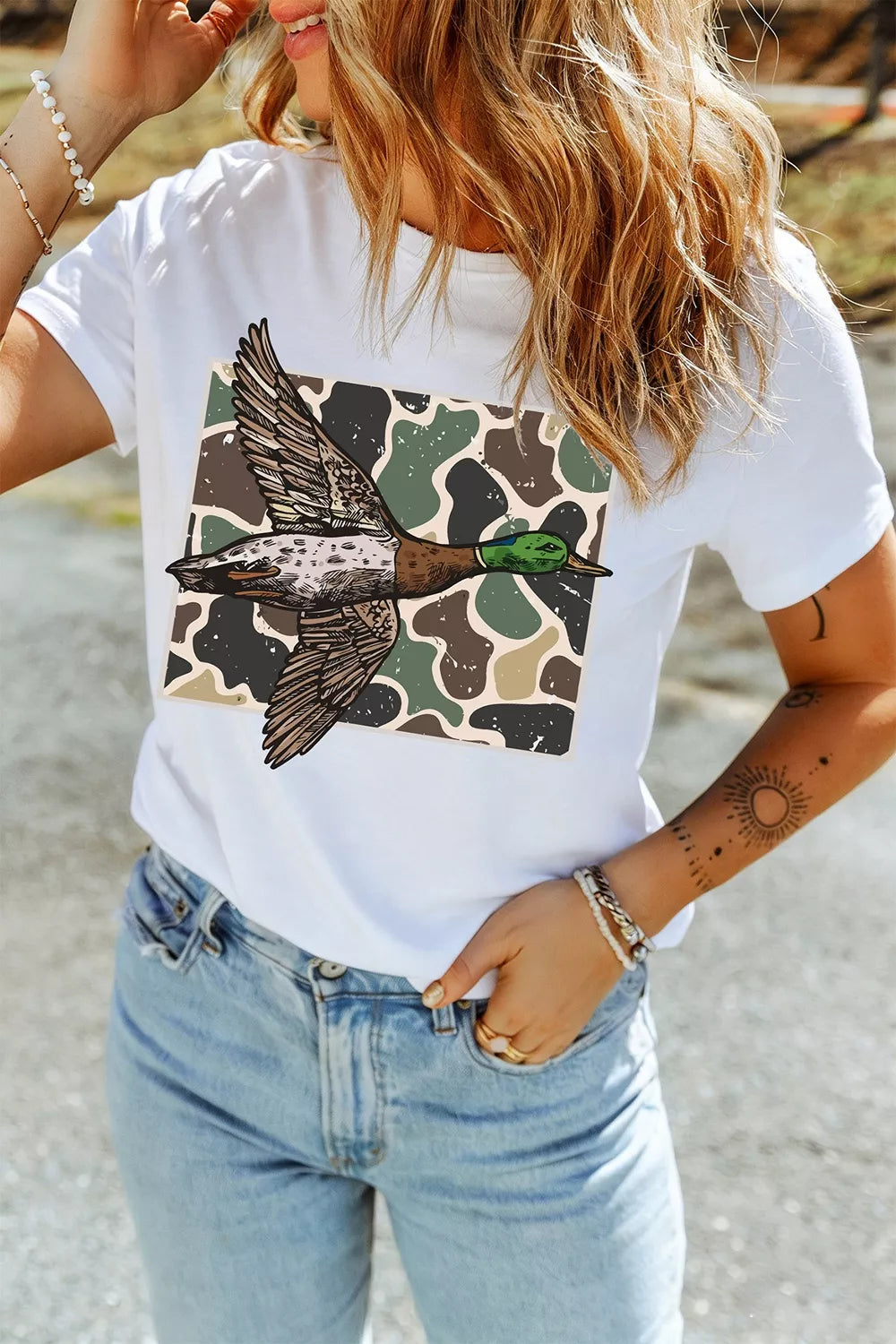 Front view of white mallard duck camouflage graphic tee worn with light blue jeans