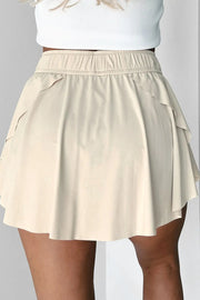 Back view of ivory skort with layered flounce panels and elastic waist.
