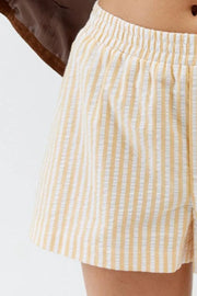 Cream striped shorts showing gathered waist and button-front detail