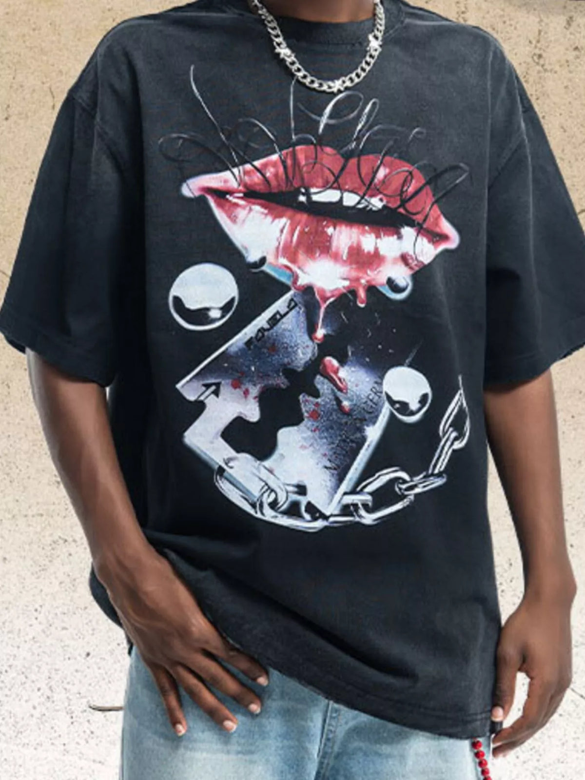Model wearing black graphic short-sleeve T-shirt with illustrated mouth and chain design