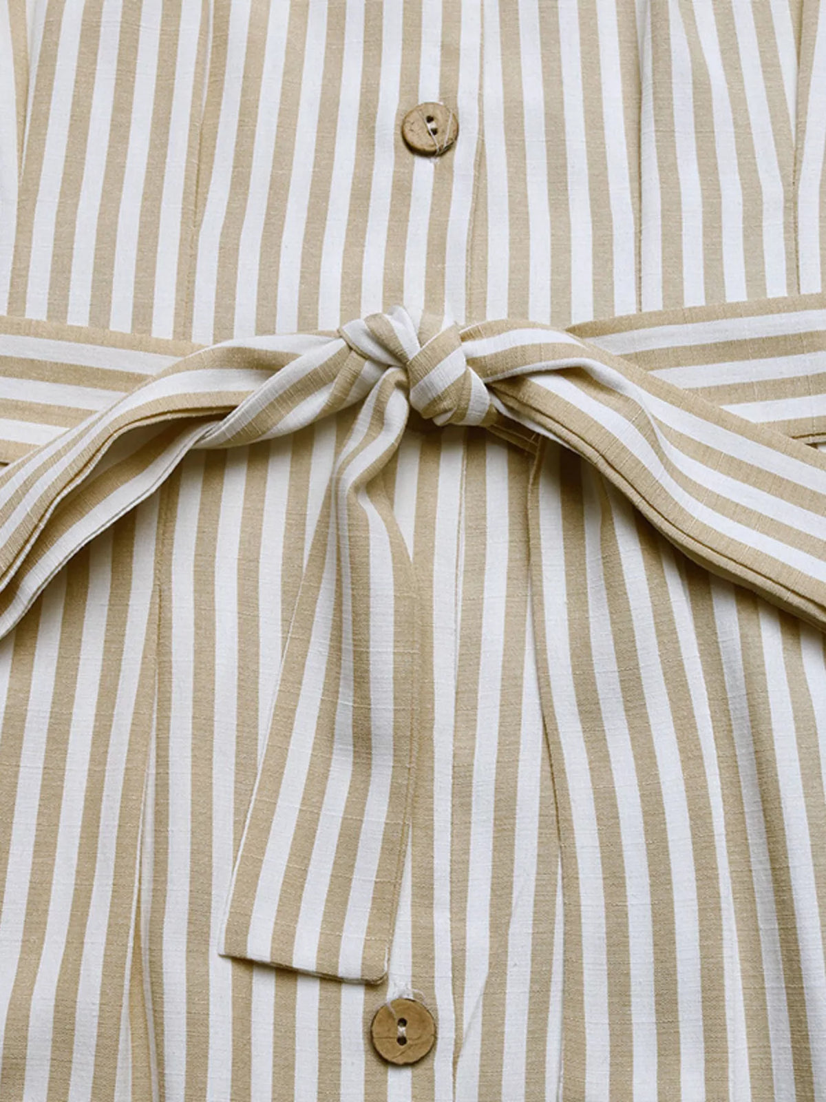 Close-up of button-front bodice and tied waist