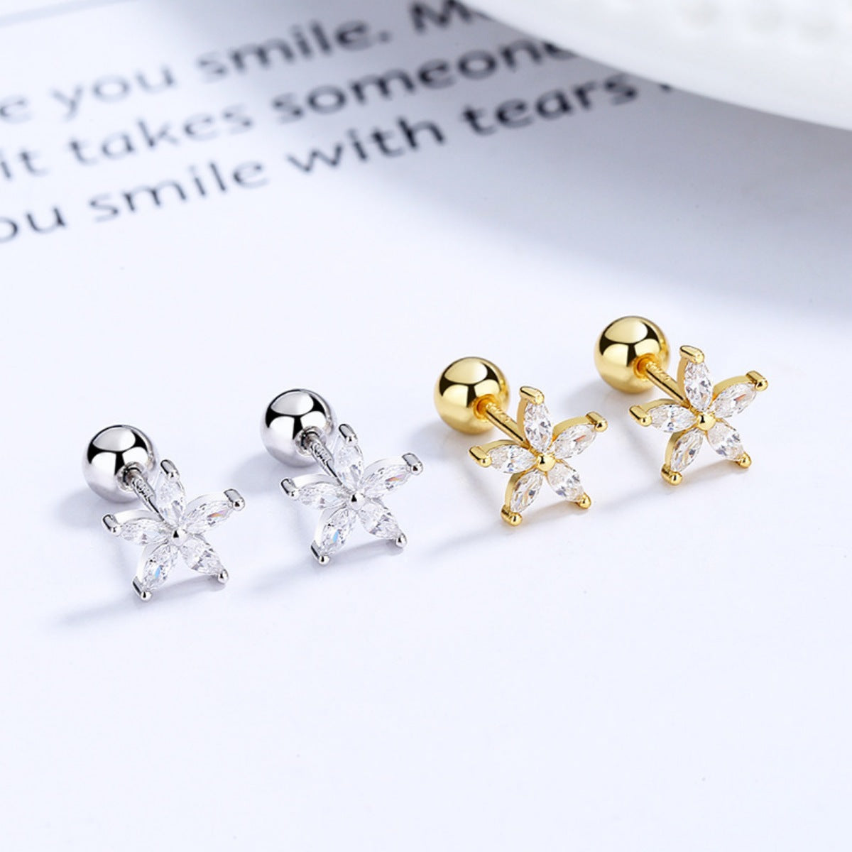 Flower stud earrings shown in silver-tone and gold-tone colour options