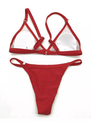 Front and back views of a red ring-detail bikini set laid flat