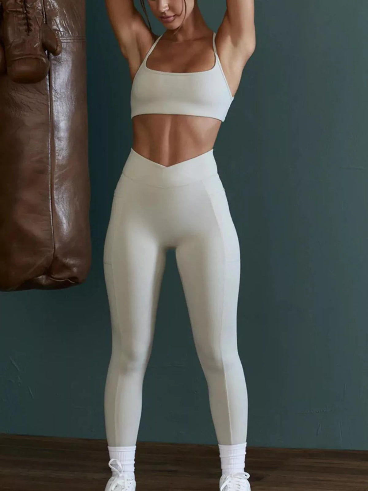 Full-length front view of seamless cross-waist cami and leggings active set