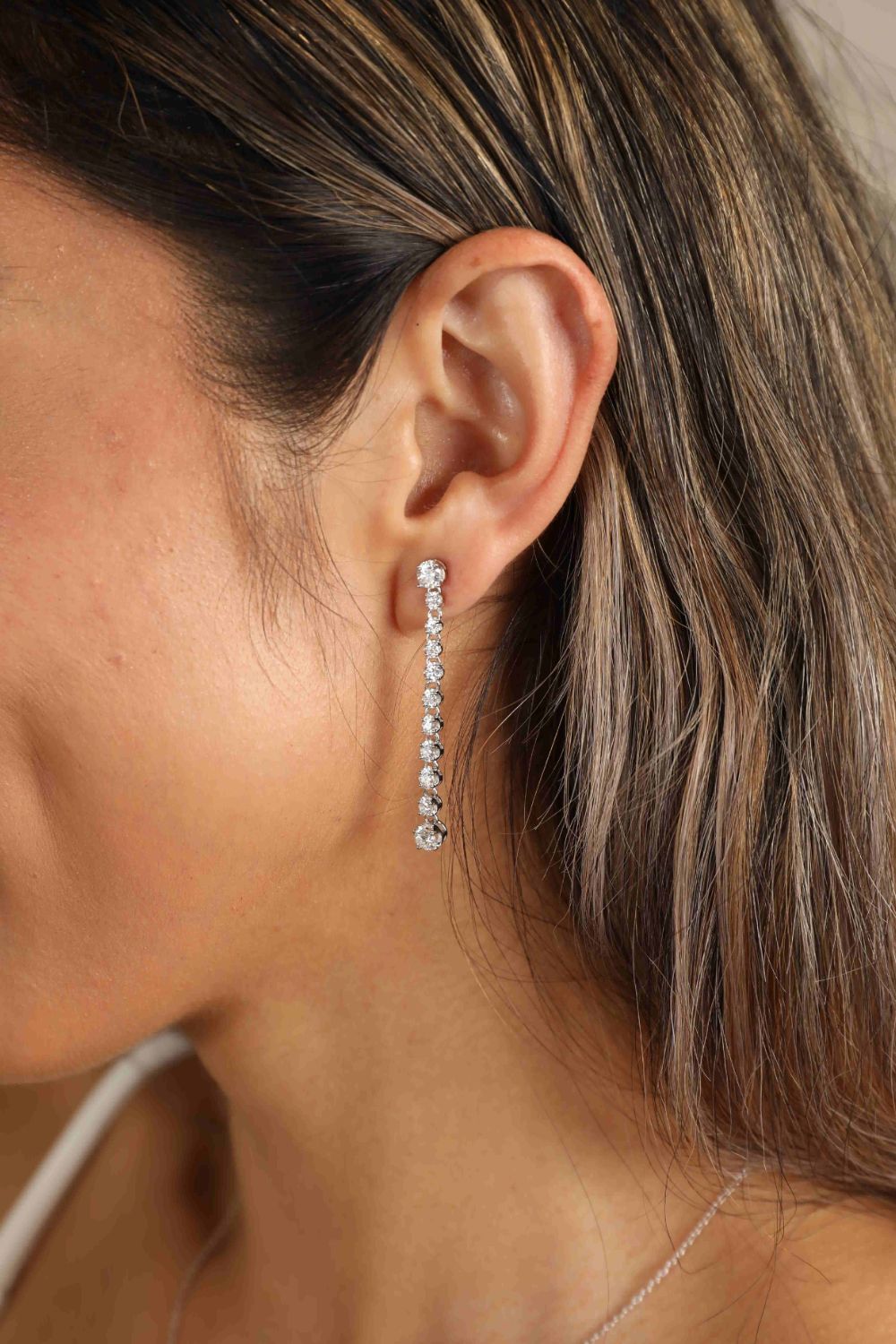 Adored 1.18 Carat Moissanite Long Earrings — Long moissanite earrings worn on an ear