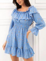 Model wearing the blue floral version of the off-shoulder ruffle dress with long sleeves.
