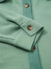 Cuff button and sleeve detail on sage shirt