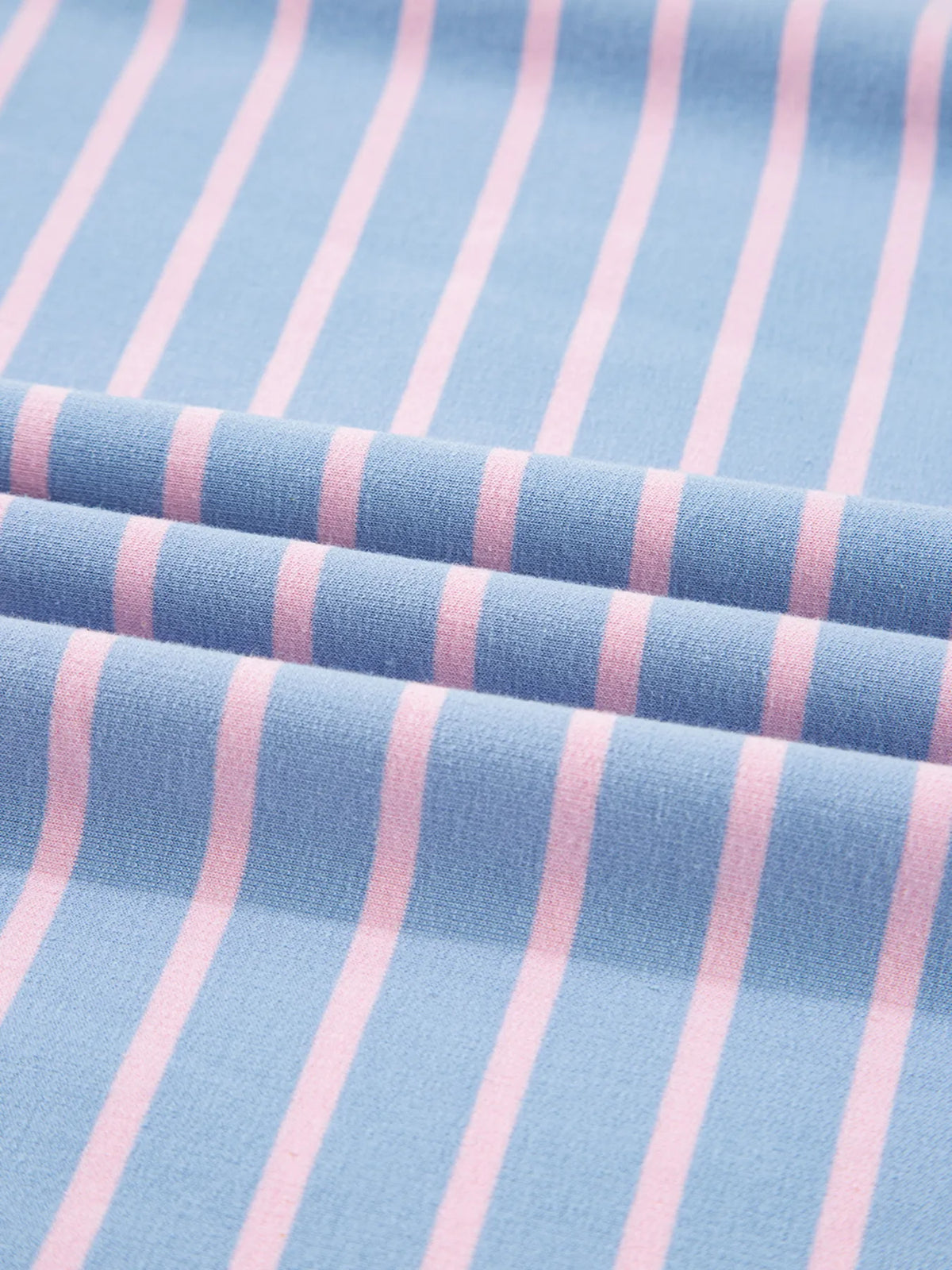 Close-up of blue fabric with narrow pink stripes
