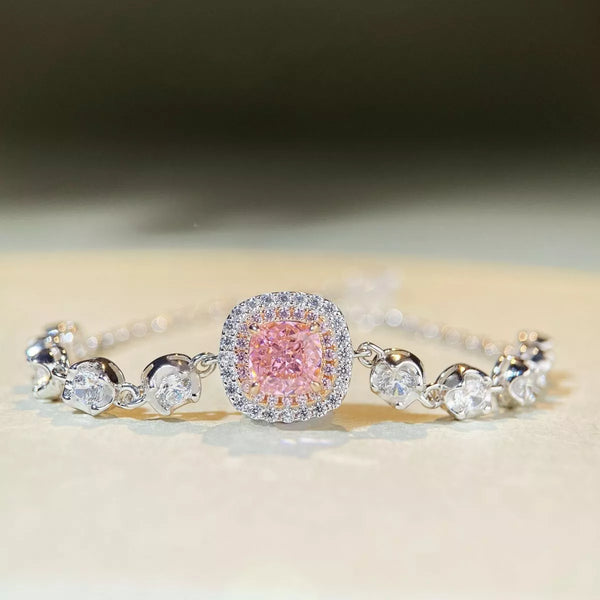 Silver-tone jewelry chain with a square blush-pink center stone, clear halo and round side stones