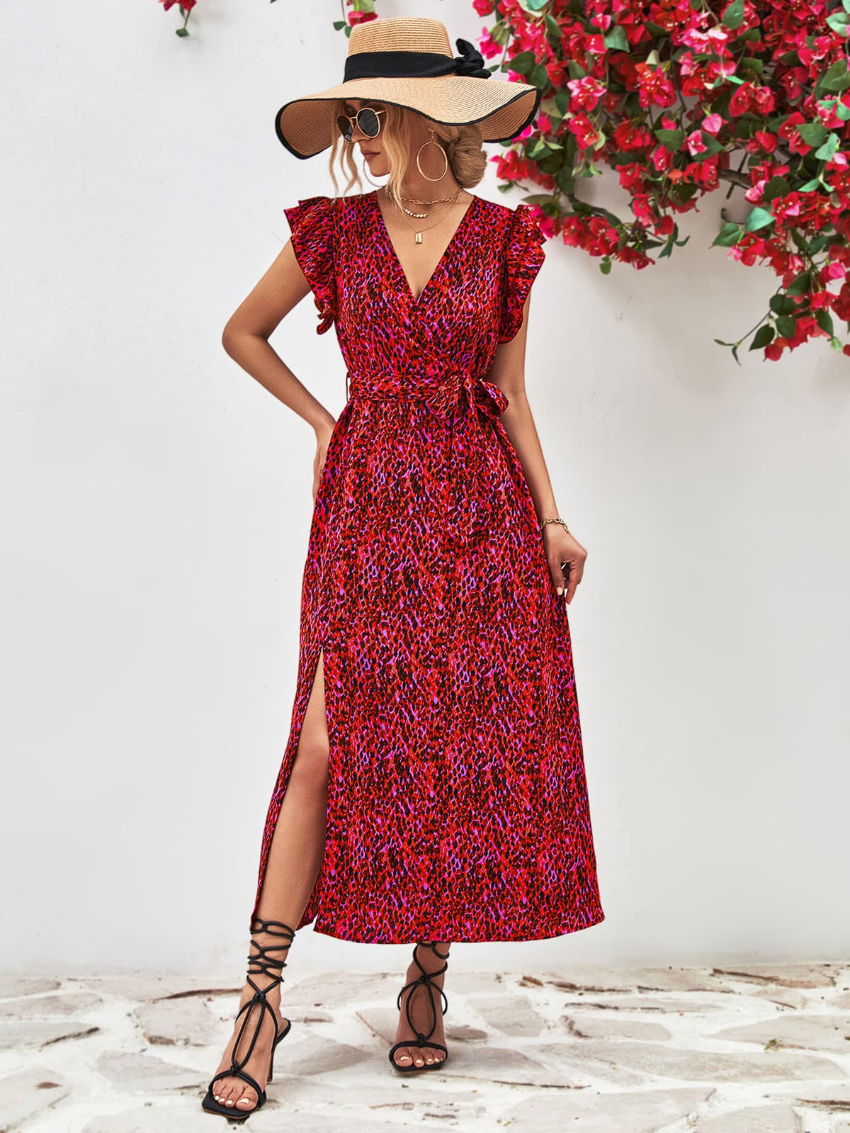 Model wearing a red printed surplice dress with flutter sleeves, front view.