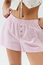Pale pink striped shorts with elastic waist and button placket