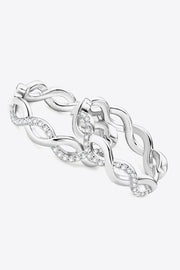 Pair of silver-tone crisscross hoops angled to show the intertwined design