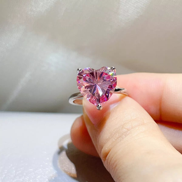 Close view of the pink heart-shaped centre stone and silver setting.