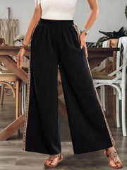 Black wide-leg pants with contrasting side embroidery