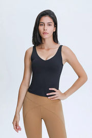 Close-up of the olive tank's V neckline and sleeveless shoulders.