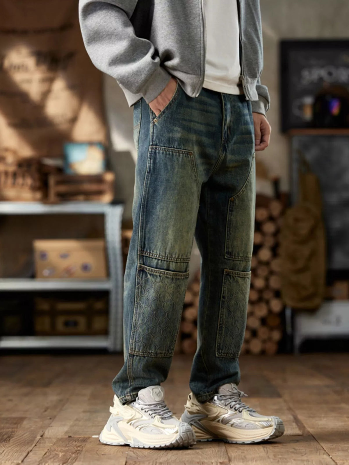 Opposite angled view of faded blue jeans with patterned knee panels