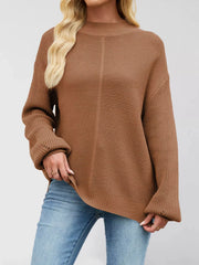 Women’s ribbed mock-neck drop-shoulder sweater in brown front view with hand at hip