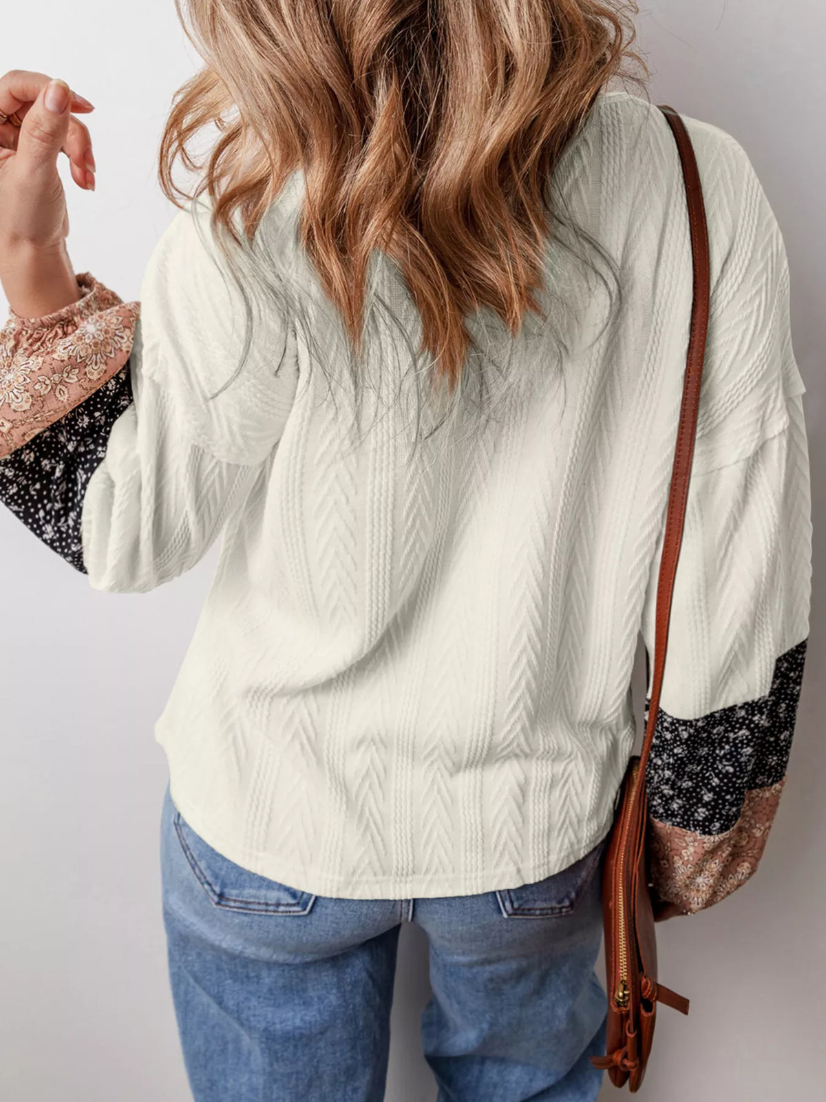 Front view showing V neckline and patchwork sleeve cuffs
