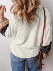 Front view showing V neckline and patchwork sleeve cuffs