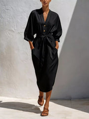 Black version of button-front tie-waist midi dress worn by model