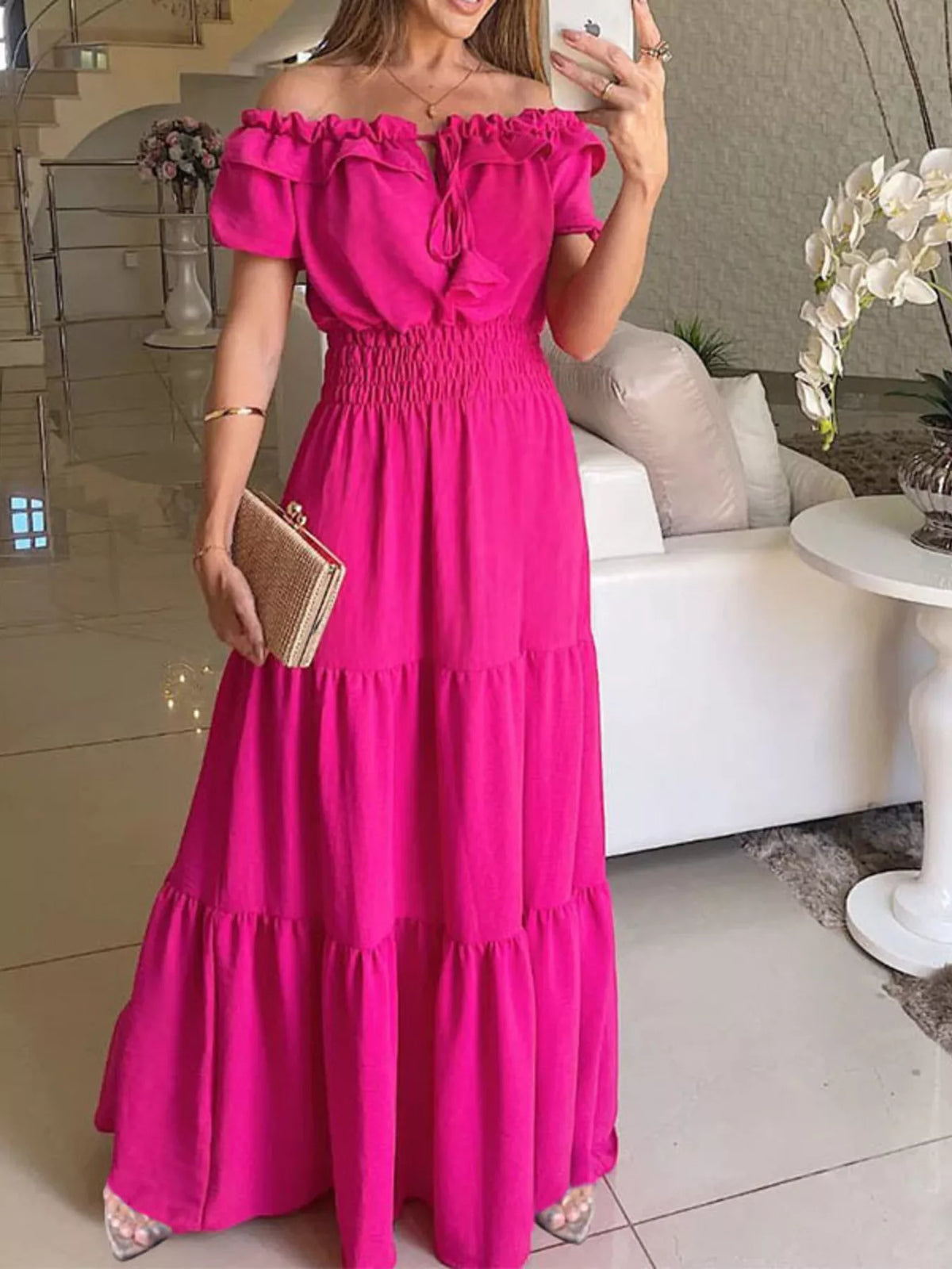 Model wearing rose-red tiered maxi dress with off-shoulder ruffle sleeves