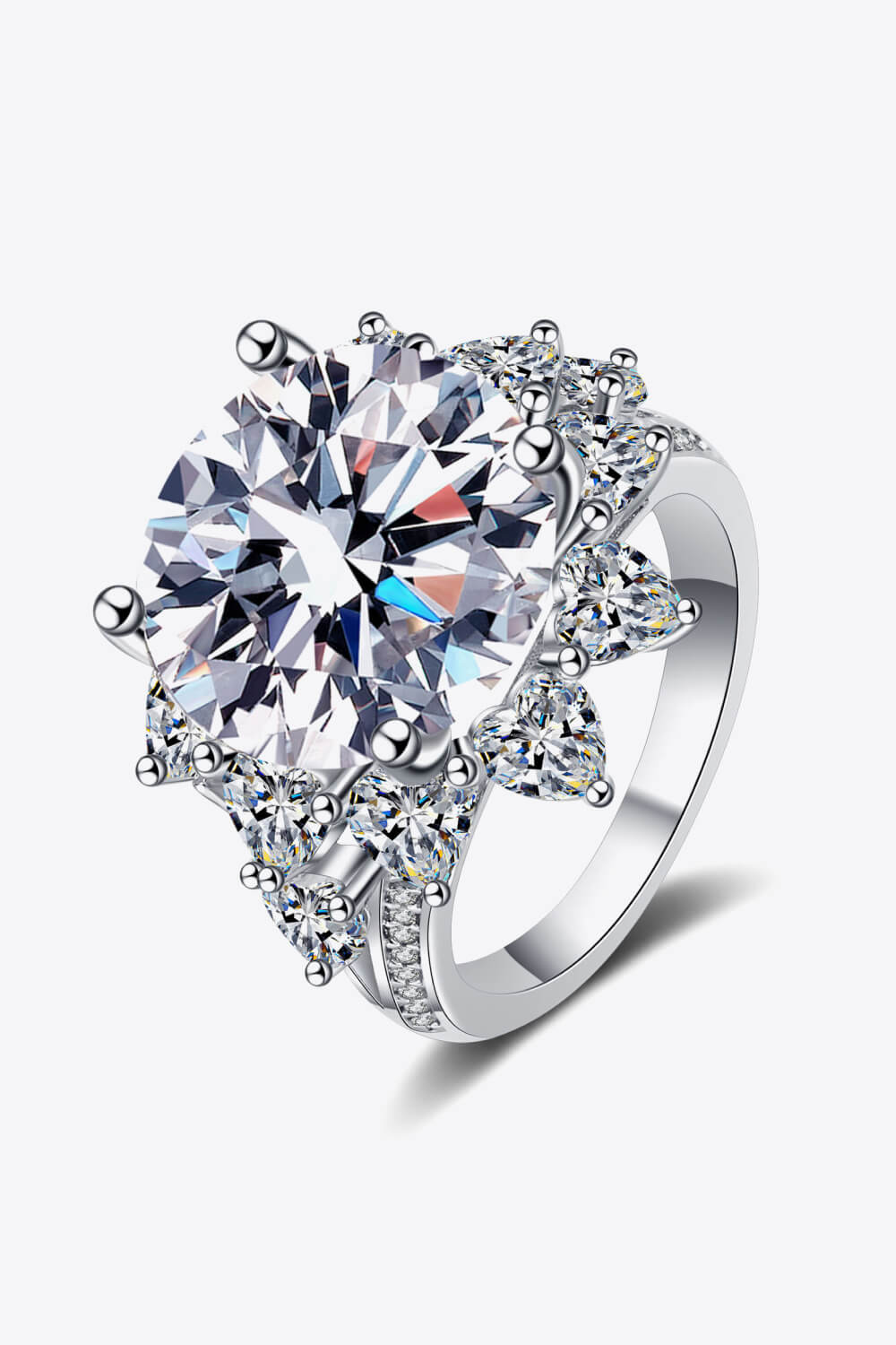 Angled close-up of silver flower-shaped moissanite ring with surrounding stones