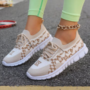 Cream mesh lace-up sneaker with tan geometric pattern, worn with light green leggings