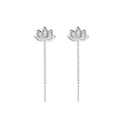 Pair of lotus-shaped silver earrings with beaded drops on white background