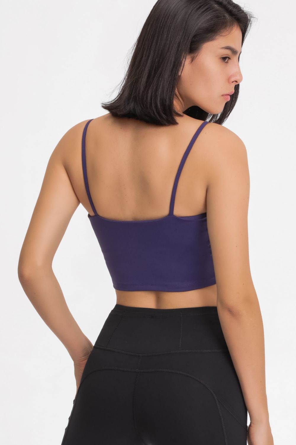 Back view showing the thin straps and cropped length of a purple scoop-neck cami.