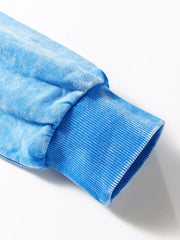 Women's mineral-wash blue raw-seam pocket sweatshirt, close-up of cuff and sleeve seam