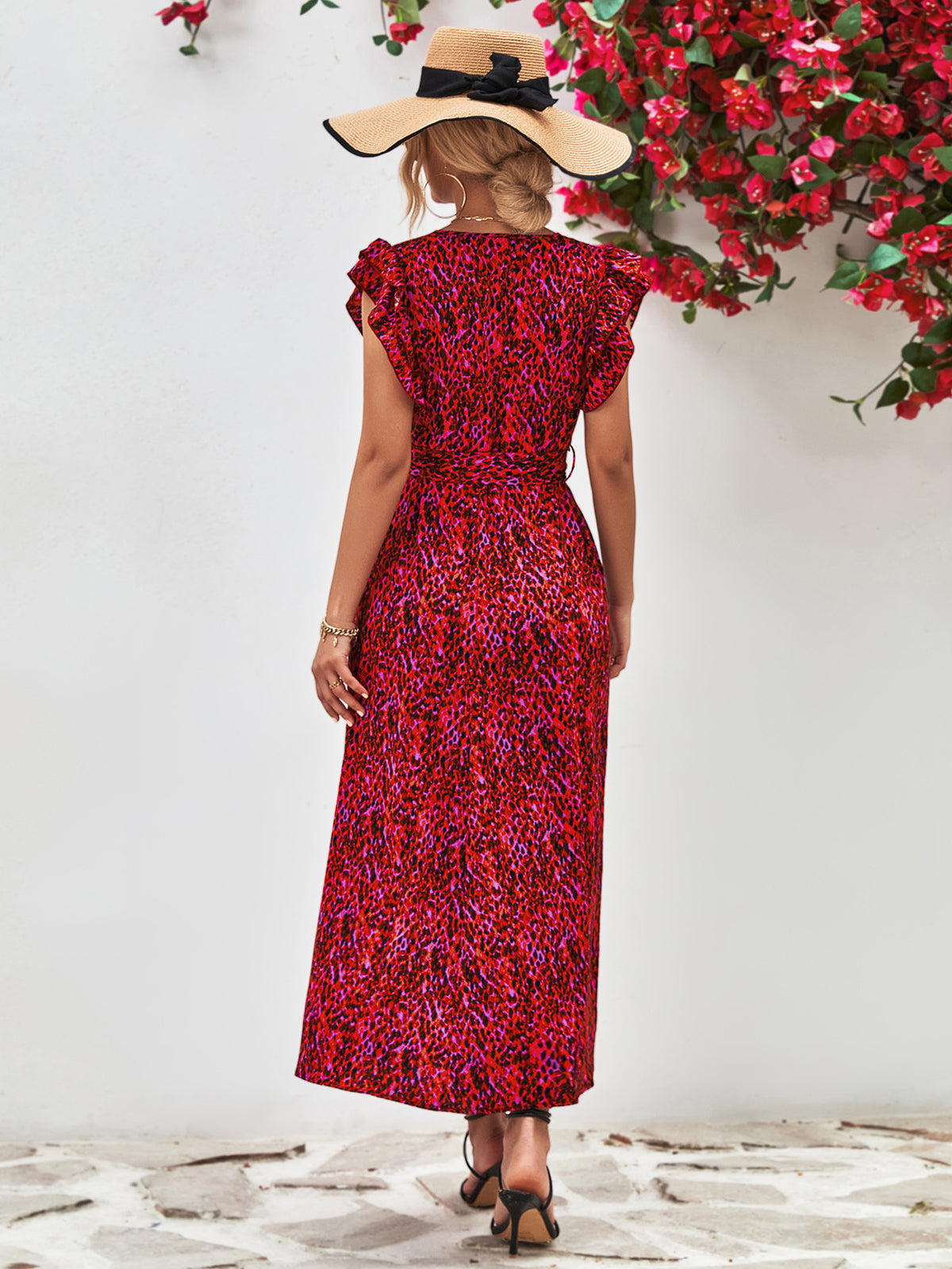 Back view of red printed surplice dress with flutter sleeves.