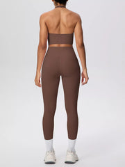 Straight back view showing brown halter top and leggings