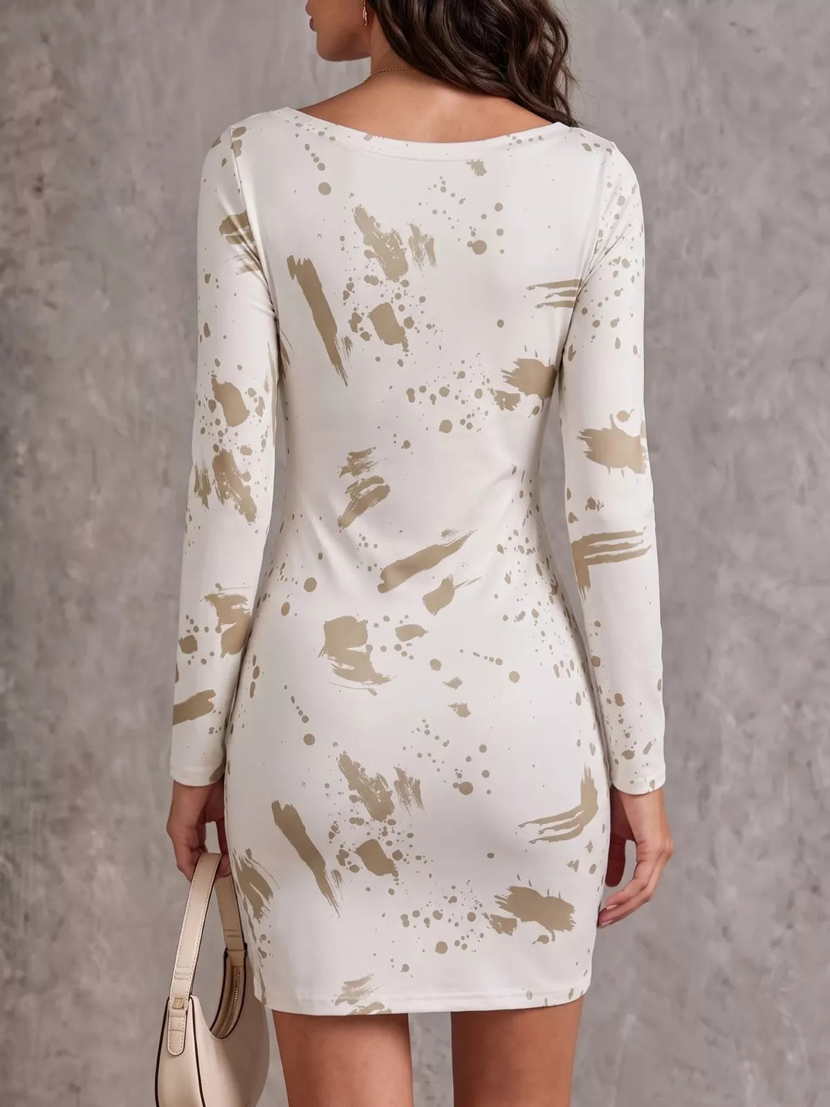 Back view of cream mini dress with long sleeves and scattered beige print