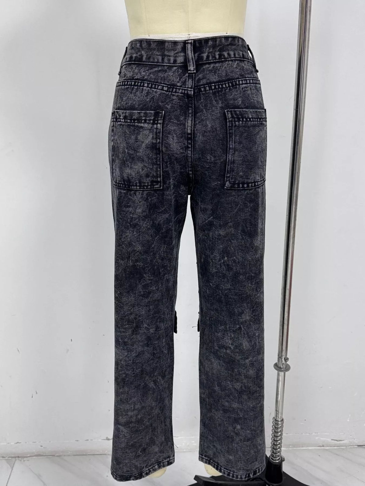 Back product view of wide-leg cargo jeans with two patch pockets
