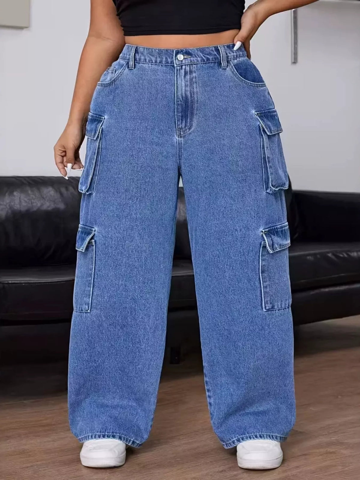 Front view of the light blue cargo jeans showing the button waist and roomy legs.