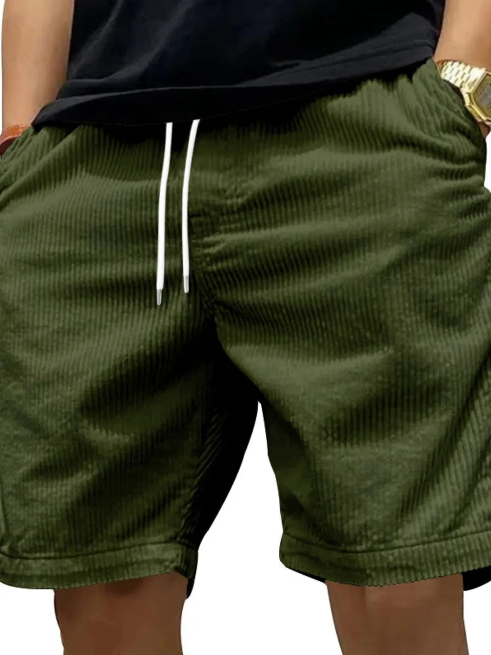 Model wearing dark green drawstring shorts