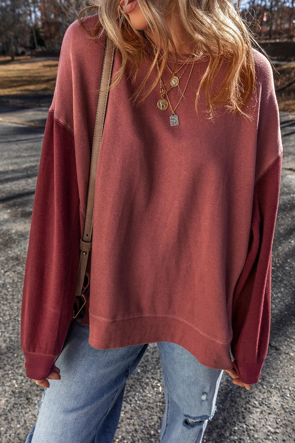 Front view of mauve sweatshirt styled with jeans